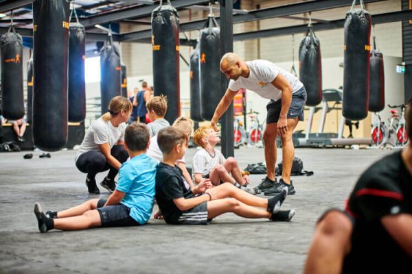 Kids and a trainor at FITKids enjoying their fitness classes.